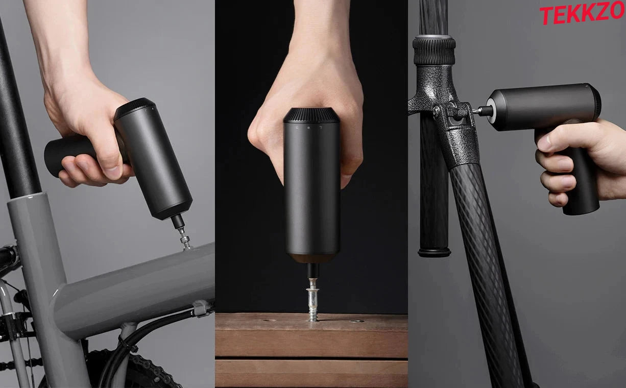 Compact black cordless electric screwdriver used on bike frame and wooden surface with ergonomic grip