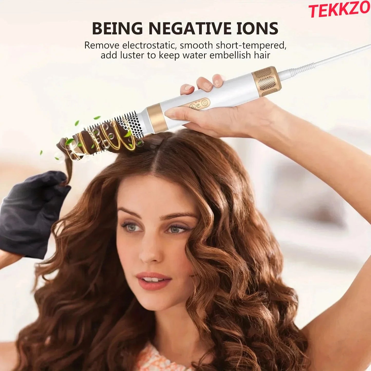 Woman styling curly brown hair with white and gold negative ion hair curling brush