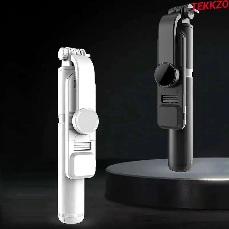 Folded compact selfie sticks in white and black with phone clamps on black background